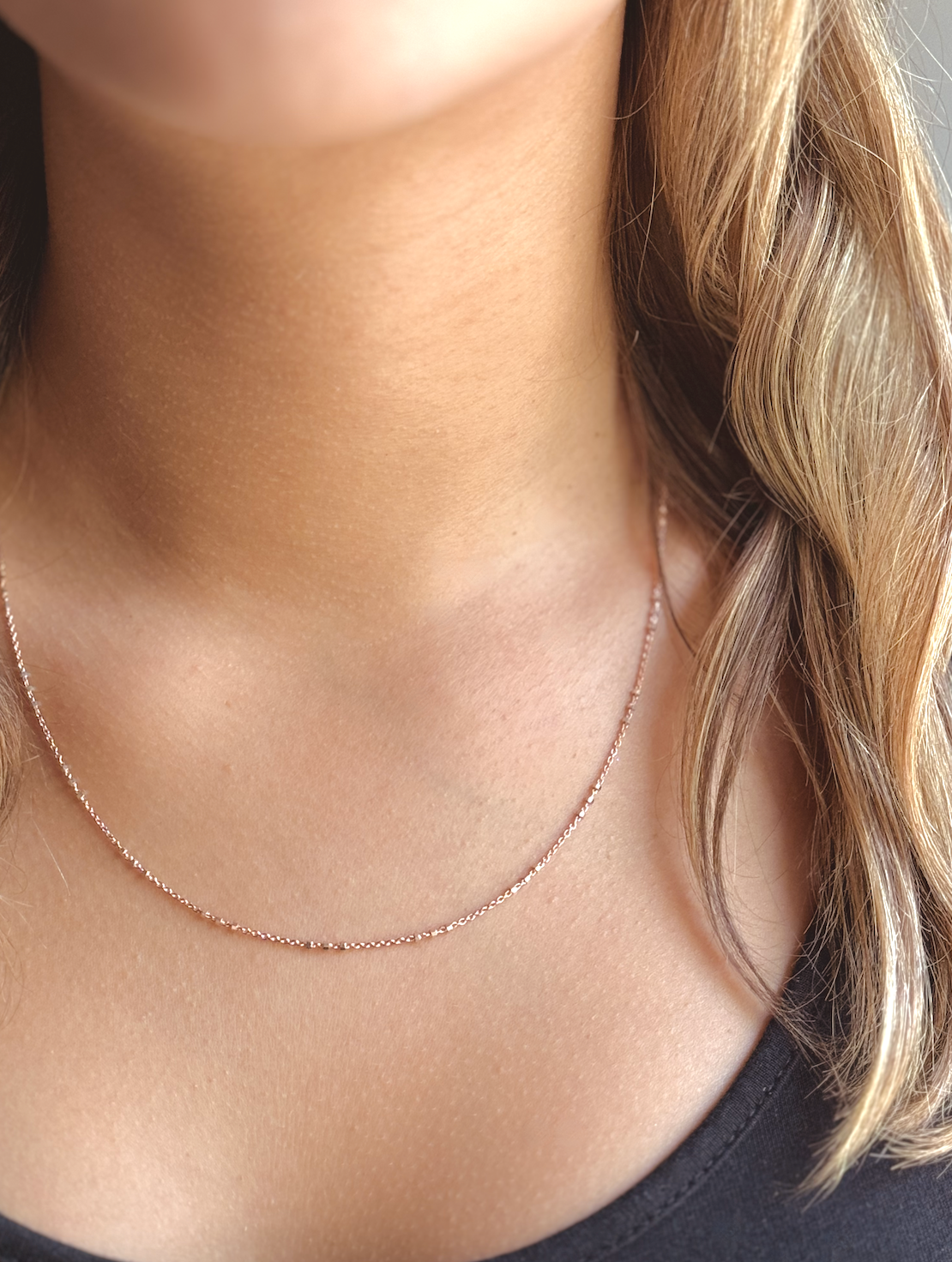 Two-tone Rose Gold and Sterling Silver satellite chain necklace featuring small silver beads spaced in sets of threes for a chic and contemporary look. Model Front View