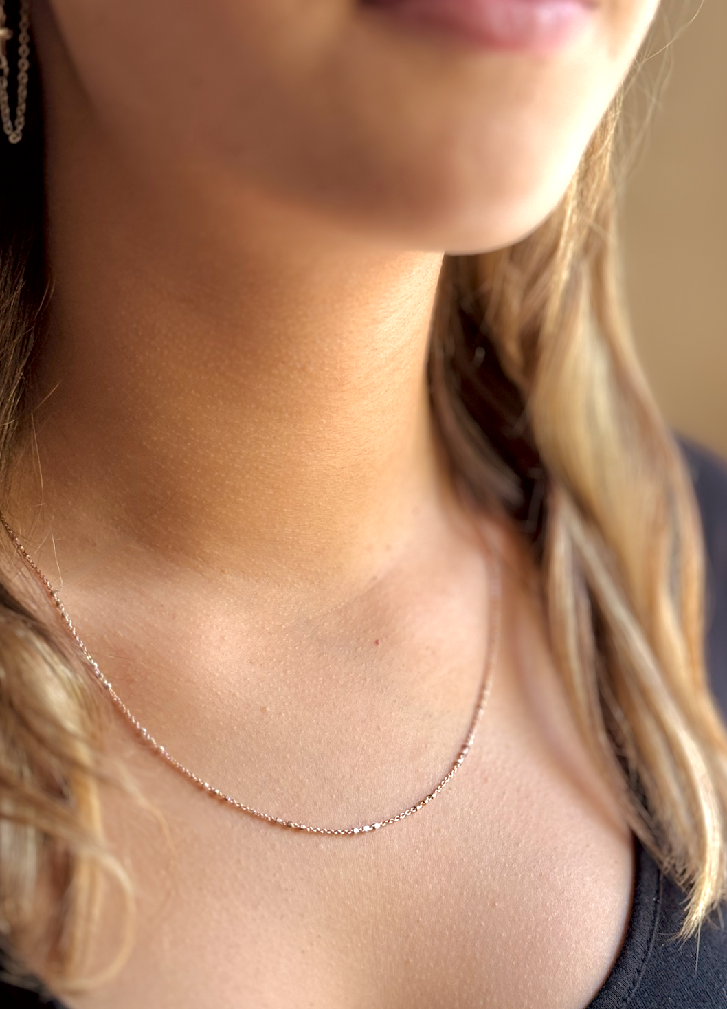 Two-tone Rose Gold and Sterling Silver satellite chain necklace featuring small silver beads spaced in sets of threes for a chic and contemporary look. Model Side View