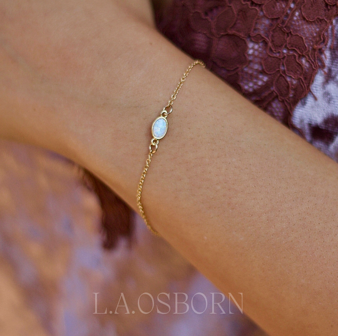 Dainty opal bracelet featuring genuine white fire opal stone on a 14K gold-filled chain, perfect for everyday wear and water-friendly.