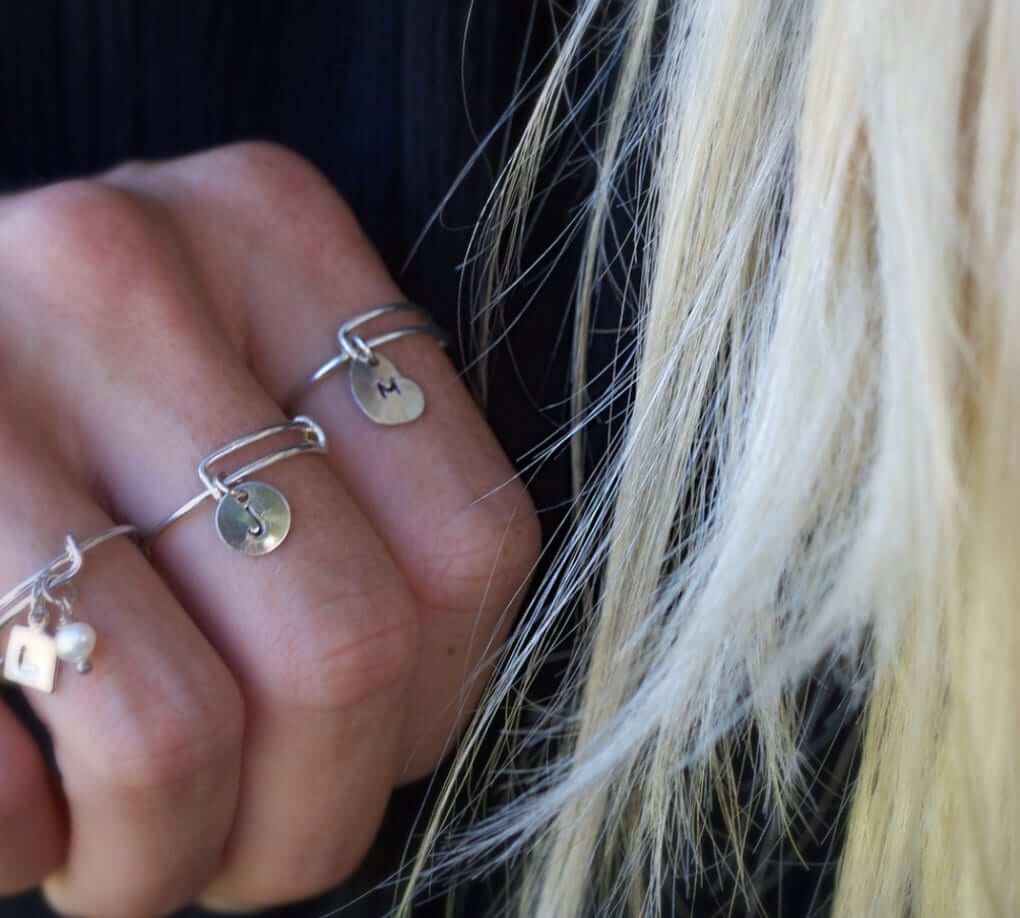 Adjustable Personalized Silver Charm Ring modeled by L.A.Osborn model close up for size