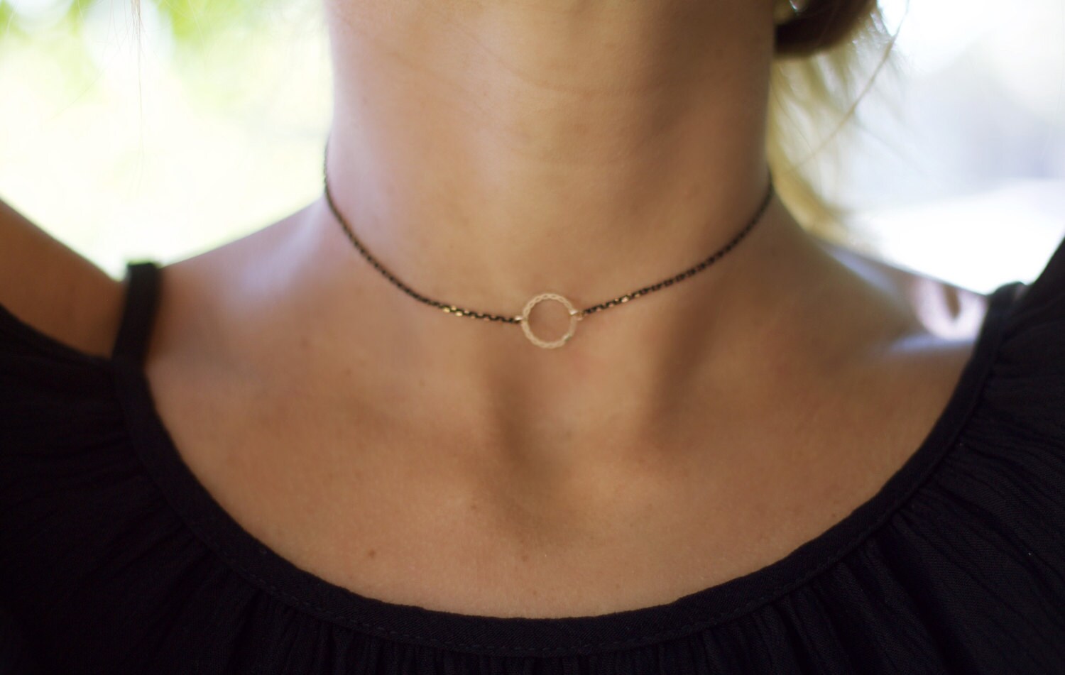 Dainty open circle choker necklace on black chain, perfect for layering with gold accessories